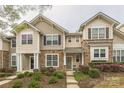 Charming townhome featuring stone accents, neutral siding, and well-maintained landscaping at 8009 Whitehawk Hill Rd, Waxhaw, NC 28173