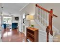 Bright foyer with hardwood floors, staircase, and a view into the living room, creating a welcoming entrance at 8009 Whitehawk Hill Rd, Waxhaw, NC 28173