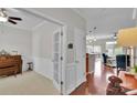 Open foyer showcasing hardwood floors, wainscoting and entry to office and open living area with lots of light at 8009 Whitehawk Hill Rd, Waxhaw, NC 28173
