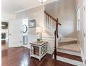 Welcoming foyer with hardwood floors, elegant staircase, and half bathroom at 8009 Whitehawk Hill Rd, Waxhaw, NC 28173