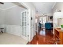 Welcoming foyer with hardwood floors, decorative molding, and access to living area at 8009 Whitehawk Hill Rd, Waxhaw, NC 28173