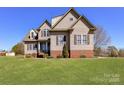 Traditional home featuring a well-kept lawn and classic design elements on a sunny day at 816 Springs Rd, Dallas, NC 28034