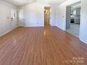 Spacious living room with hardwood floors and an open layout, offering versatility and a seamless flow throughout the home at 867 Meadow Hill Ct, Lincolnton, NC 28092