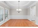 Elegant dining room featuring hardwood floors, decorative molding, and stylish chandelier at 8806 Cool Meadow Dr, Huntersville, NC 28078