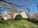 A view of a well maintained lawn and landscaping of a home in a suburban neighborhood at 104 Johnsbury Dr, Stanley, NC 28164