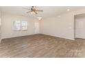 Bright living room features wood-look floors, ceiling fan, and plenty of natural light at 1120 Freeman View Dr, Albemarle, NC 28001