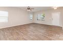 Bright living room features wood-look floors, ceiling fan, and plenty of natural light at 1120 Freeman View Dr, Albemarle, NC 28001