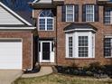 Charming brick home with a well-manicured lawn, black shutters, and front door at 12729 Mcginnis Ln, Huntersville, NC 28078