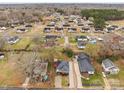 Wide aerial view of a neighborhood showcasing the layout and proximity of homes with mature trees in the yards at 133 2Nd Ave, China Grove, NC 28023