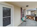 Inviting front porch with comfortable seating, offering a relaxing outdoor space with stylish black and wood railing at 133 2Nd Ave, China Grove, NC 28023