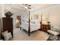 Luxurious main bedroom with a tray ceiling, plush carpet, and lots of natural light at 141 Rhuidean Ct, Troutman, NC 28166