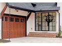 Close-up of garage and front door showcasing brick steps and wreaths on windows at 1711 Brook Rd, Charlotte, NC 28205