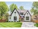 Beautiful two-story home with a manicured lawn, contrasting trim, and a modern glass front door at 1711 Brook Rd, Charlotte, NC 28205
