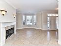 Cozy living room features tile flooring, a fireplace, and large windows, creating a warm and inviting space at 178 Harper Lee St, Davidson, NC 28036