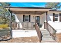 Welcoming covered front porch with dark wood railings and steps leading up to the front door at 188 Bailey Rd, Mooresville, NC 28117