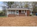 Inviting single story home with a brick facade and covered front porch, offering a cozy curb appeal at 208 Tomberlin Rd, Mount Holly, NC 28120