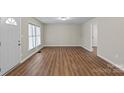The living room features hardwood floors, a front door and a large window at 208 Tomberlin Rd, Mount Holly, NC 28120