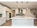 Modern kitchen featuring a large quartz island, stainless steel appliances, and stylish pendant lighting at 211 Halemarg Dr, Belmont, NC 28012