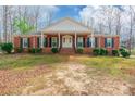 Charming single-story brick home with black shutters, landscaped yard, and inviting entrance at 406 Forest Dr, York, SC 29745