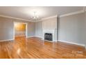 Bright living room with hardwood floors, fireplace, and decorative chandelier at 406 Forest Dr, York, SC 29745