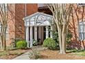 Charming entrance to building 5601 featuring classic columns and manicured landscaping at 5601 Fairview Rd # 24, Charlotte, NC 28209