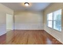 Light-filled dining room boasts hardwood floors, decorative molding, and a large window at 620 Weyburn Nw Dr, Concord, NC 28027