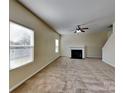 Cozy living room features a fireplace, neutral carpet, and ample natural light at 620 Weyburn Nw Dr, Concord, NC 28027