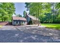 Exterior home view features a detached garage, ample parking, and a well-kept yard at 6688 Pine Forest Dr, York, SC 29745