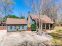 Charming home with a detached garage featuring an inviting exterior and well-manicured surroundings at 6688 Pine Forest Dr, York, SC 29745