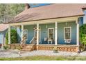 Comfortable front porch with seating, a swing, and charming details, perfect for relaxing outdoors at 6688 Pine Forest Dr, York, SC 29745