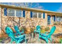 Backyard fire pit area with four Adirondack chairs and manicured landscaping at 6956 Oakstone Pl, Charlotte, NC 28210