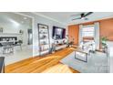 Cozy living room with hardwood floors and ladder shelf decor at 6956 Oakstone Pl, Charlotte, NC 28210