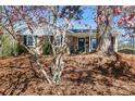 Charming brick home framed by blossoming magnolia trees at 7124 Brynhurst Dr, Charlotte, NC 28210