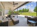 A beautifully covered patio with outdoor seating and dining options, offering great outdoor entertaining at 8310 Sandstone Crest Ln, Indian Land, SC 29707