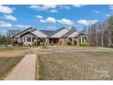 Wide front yard with walkway to the home's front door and lush, mature landscaping at 1030 Hurley School Rd, Salisbury, NC 28147