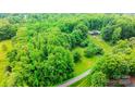 Expansive wooded property showcasing the home's private setting and the surrounding natural beauty, with a pool at 1080 Rolling Green Dr, Newton, NC 28658