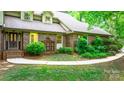 Beautiful brick home with manicured landscaping and charming details, creating an inviting and picturesque facade at 1080 Rolling Green Dr, Newton, NC 28658