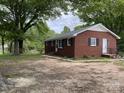 Traditional brick home featuring black shutters, a level lot, and landscaped yard at 1105 Carnation Ln, Sharon, SC 29742