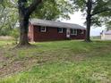Quaint brick home with well-maintained lawn and mature trees offers classic curb appeal at 1105 Carnation Ln, Sharon, SC 29742