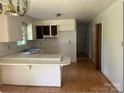 Functional kitchen space with ample cabinets, countertops, and an eat-in breakfast bar at 1327 Crestview Dr, Shelby, NC 28150