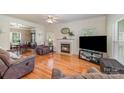 Cozy living room featuring a fireplace, hardwood floors, and comfortable seating at 13602 Red Wine Ct, Charlotte, NC 28273