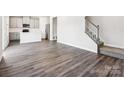 Open-concept living room with wood-look floors and a view to kitchen and stairway at 150 Aberdeen Dr, Salisbury, NC 28144