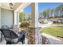Cozy front porch view showcasing stone pillar details and neighborhood scenery at 152 Broadleaf Dr, Denver, NC 28037