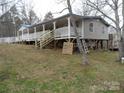 Side view of home with a long porch that runs along the side and stairs at 160 Icard Ridge Rd, Granite Falls, NC 28630