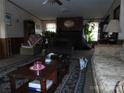 Comfortable living room featuring plants and a dark brown wood fireplace at 160 Icard Ridge Rd, Granite Falls, NC 28630