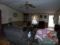 Living room with a plush sofa, a recliner, and a window with curtains at 160 Icard Ridge Rd, Granite Falls, NC 28630