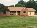 Inviting single-story home with brick exterior, manicured lawn, and an attached two-car garage at 1922 Dogwood Flower Ln, Lincolnton, NC 28092