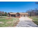 Traditional brick home featuring a cozy porch, two-car garage, and a spacious driveway at 1922 Dogwood Flower Ln, Lincolnton, NC 28092