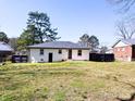 Large backyard with a well-maintained lawn, fenced area, and the rear view of the house at 2318 Knight Dr, Gastonia, NC 28052