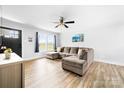 Comfortable living room with a large sectional sofa, ceiling fan, and natural light from a large window at 2318 Knight Dr, Gastonia, NC 28052